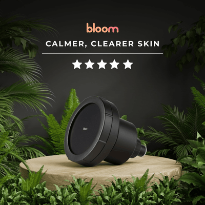 Bloom Filtered Showerhead on display among greenery with text promoting calmer, clearer skin and five stars rating.